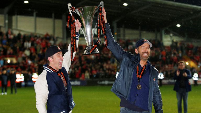 Wrexham's Hollywood Owners Ryan Reynolds and Rob McElhenney lift the champions trophy