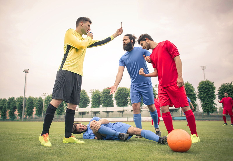 player being booked by a referee in football