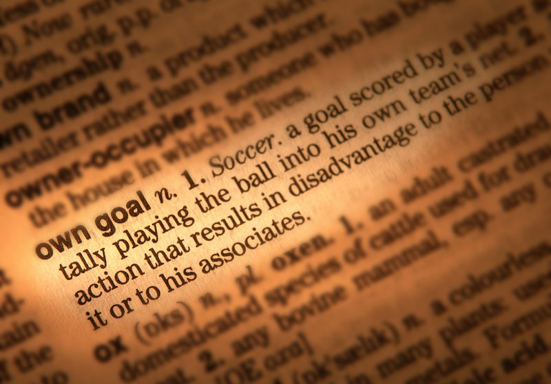 own goal definition in a dictionary shown close up
